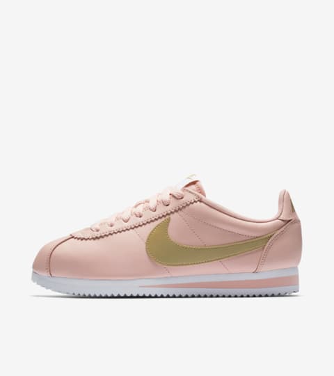 pink nike cortez with gold swoosh