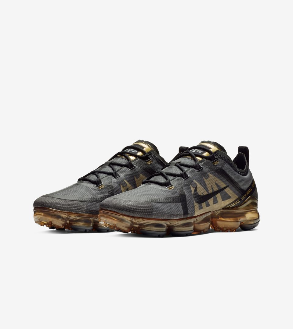 black vapormax with gold tick