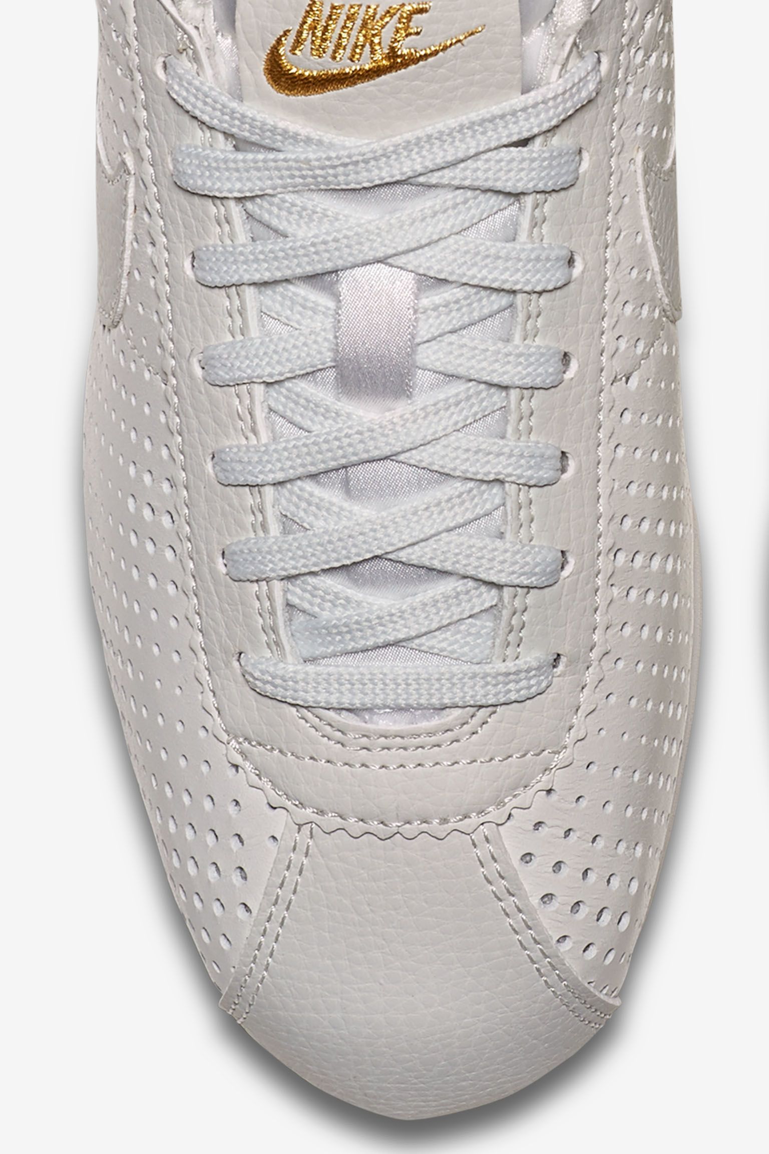 white and gold nike cortez