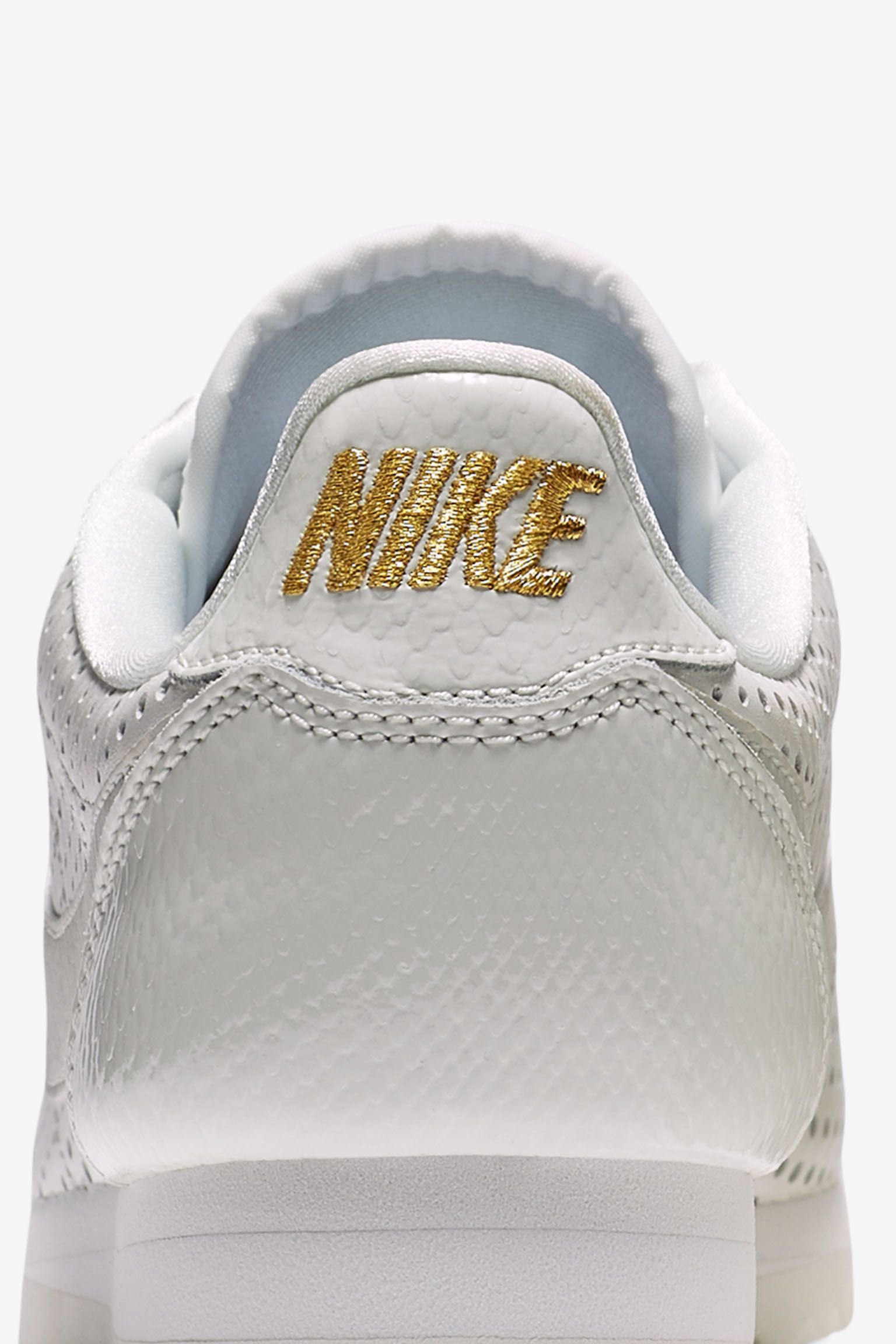 white and gold nike cortez